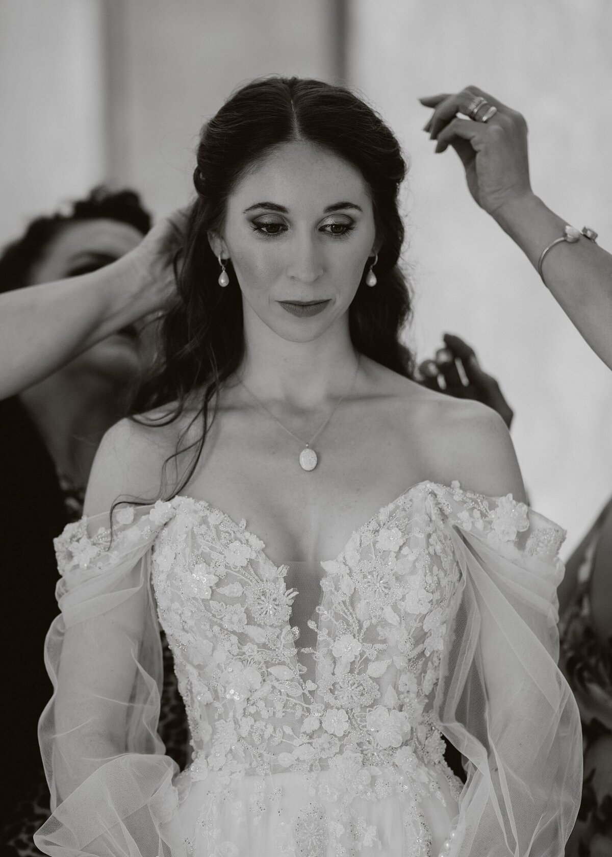 Bride having finishing touches done on her wedding morning