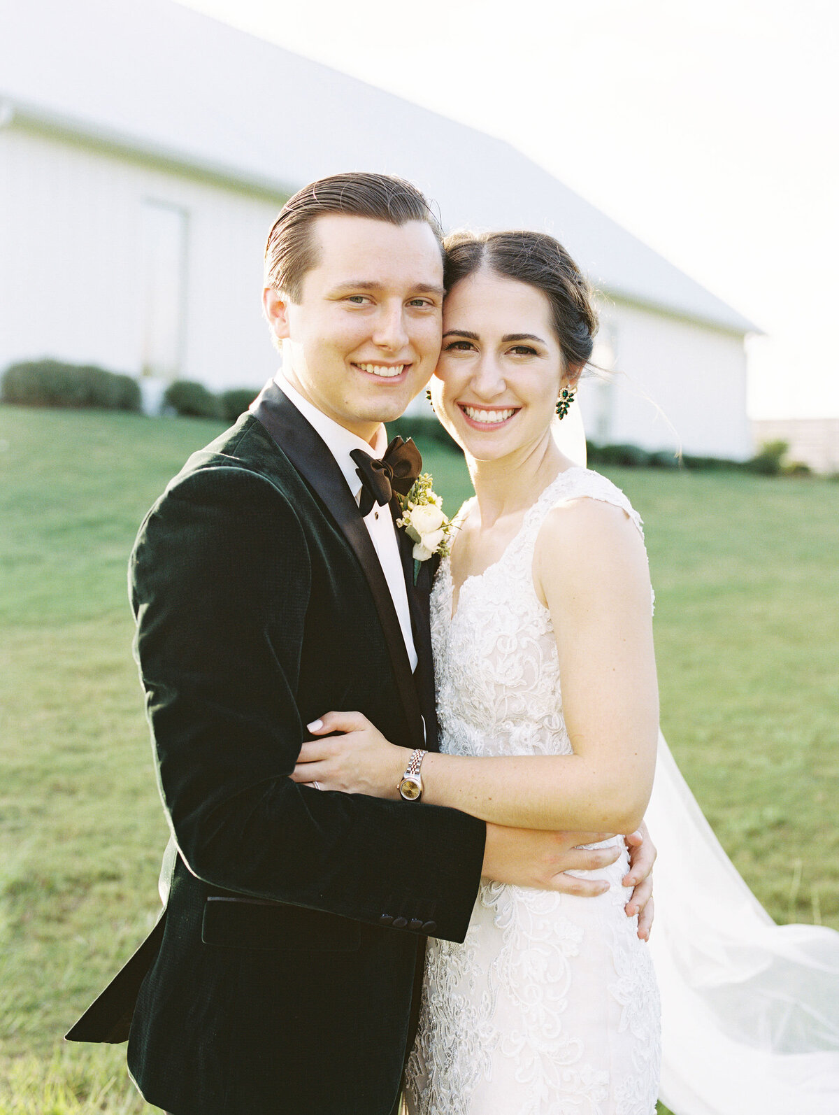 A Couple smiles at the camera at their wedding venue in Montgomery, TX called The Farmhouse