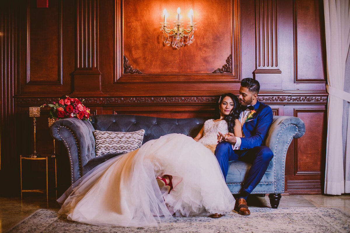 Indian christian bride sitting on a sofa at the new hyde park inn on their wedding day