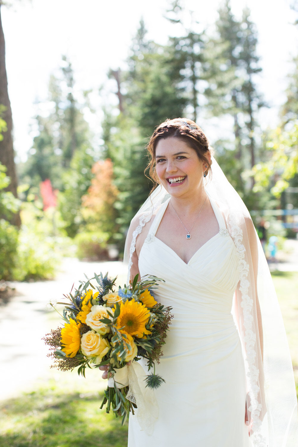Smiling bride holding her yellow bouquet