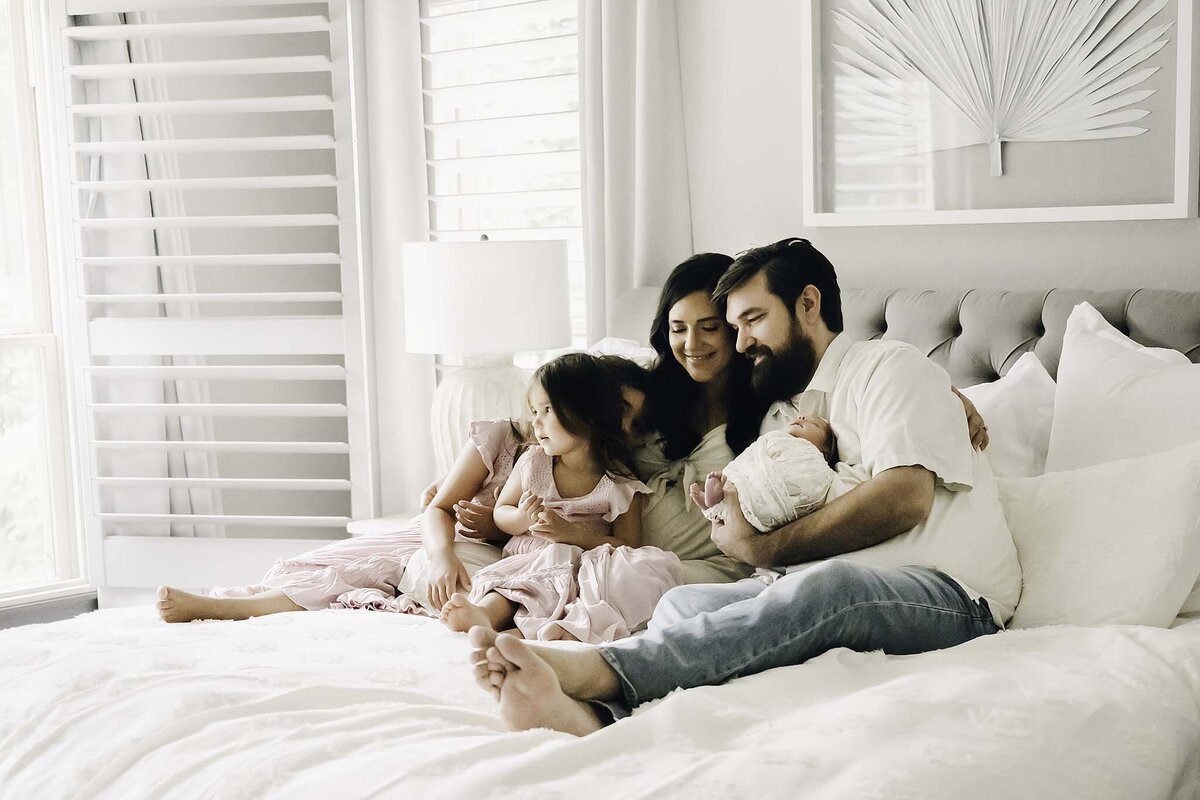 Famiy on bed - newborn photography