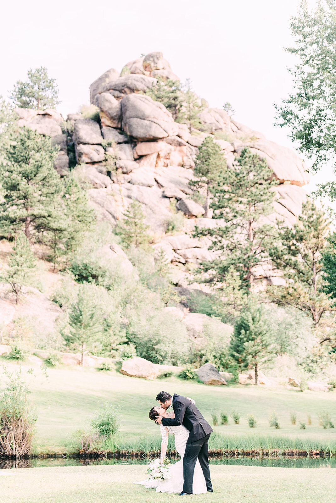 bride and groom kiss on their wedding day at the black canyon inn venue