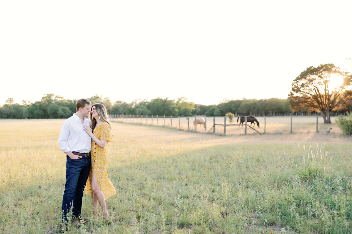 sunset engagement photos in a field