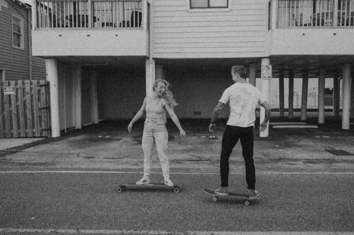 couple skateboards down street