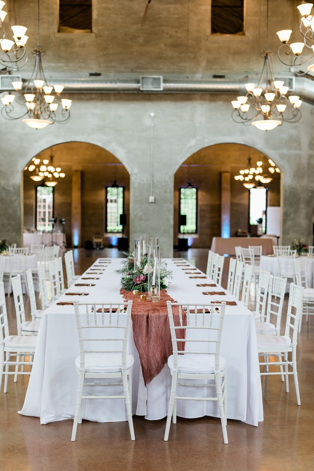 Fall inspired reception decor with burgundy colors and greenery at the reception space at Olde Dobbin Station.