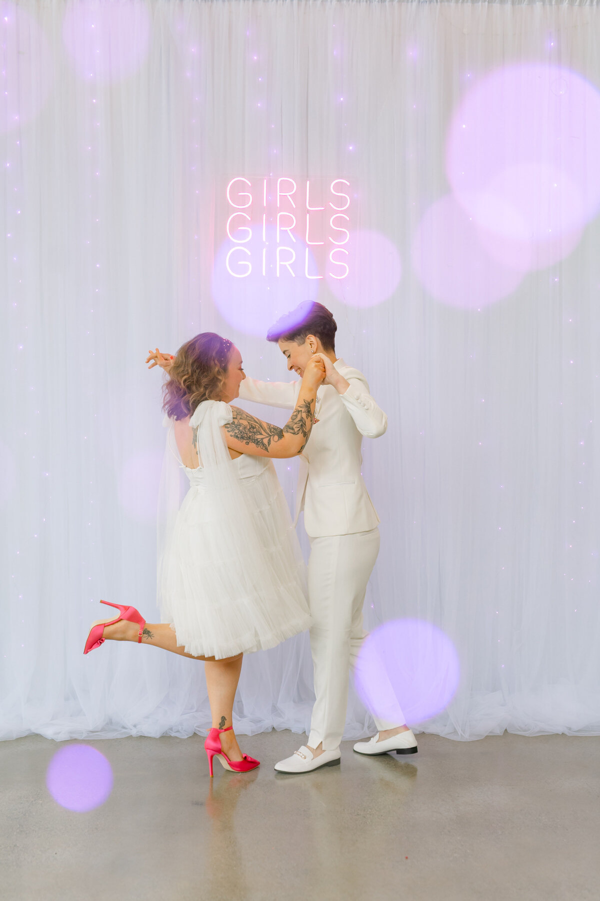 Brides hand in hand with one doing a leg pop