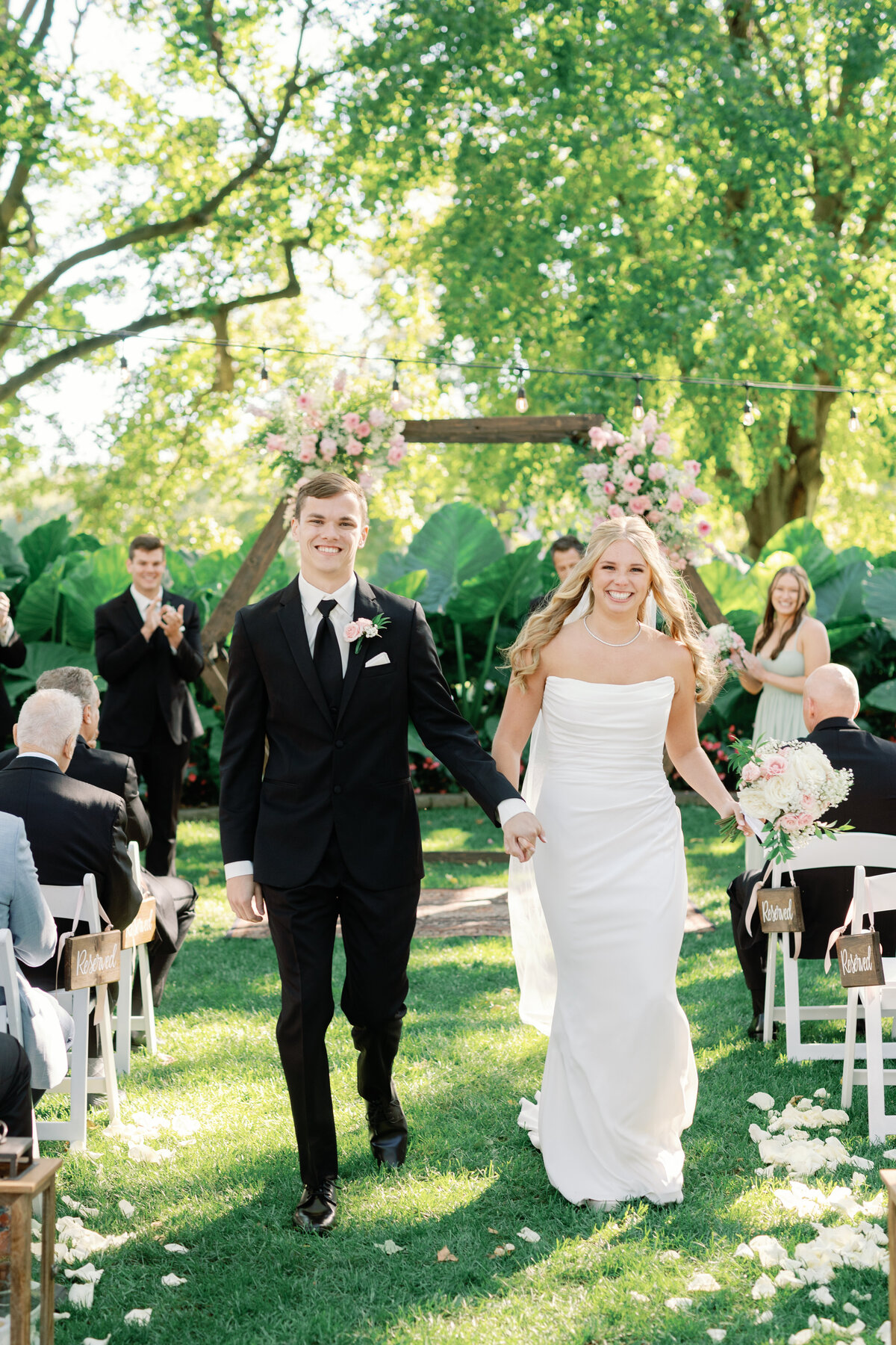 Bride and Groom walk down the aisle after being pronounced husband and wife by Lacey Graham Springfield Illinois wedding Photographer