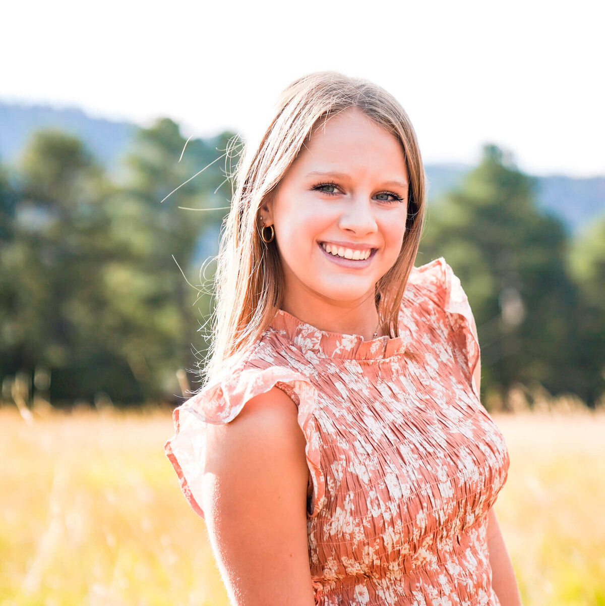 denver photography senior pictures - closeup of girl smiling in field