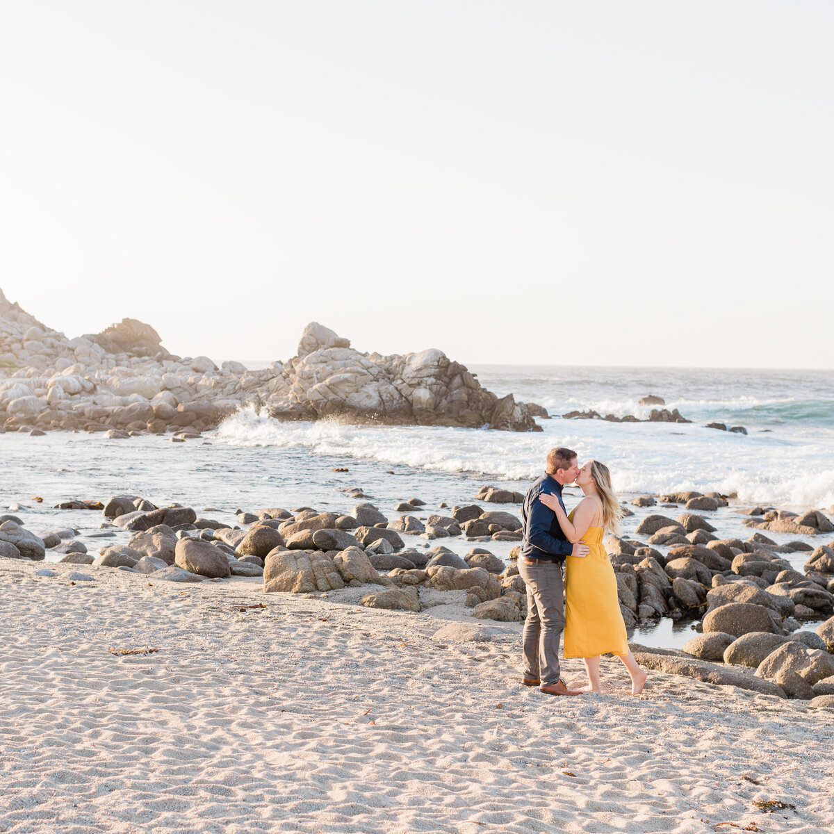Couple on beach in pacific grove engagement photograph