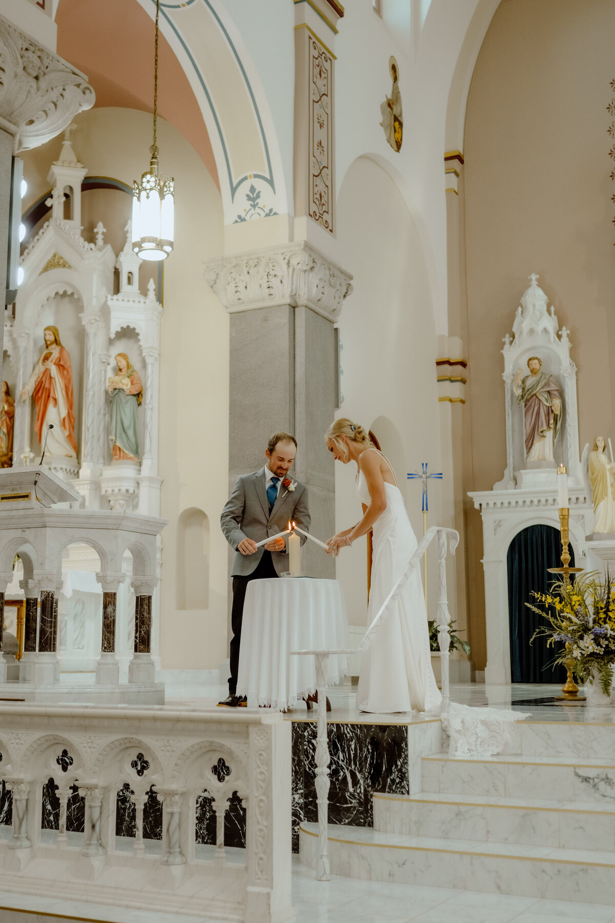 bride and groom lighting their unity candle at their church wedding