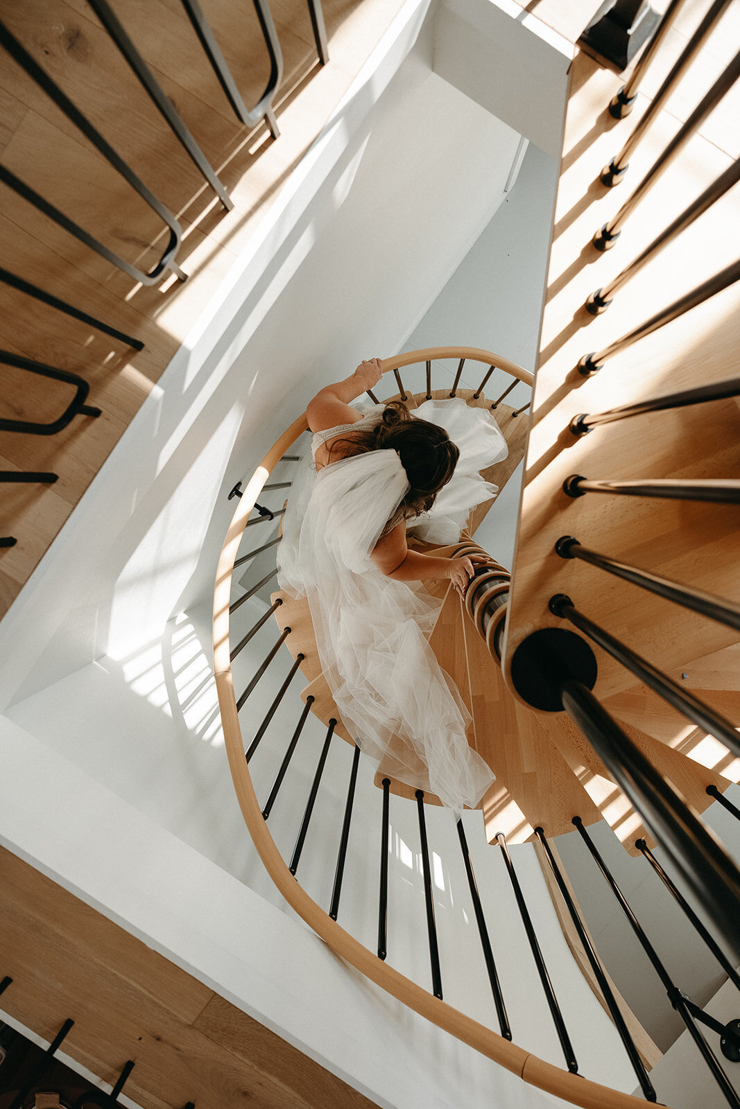 bride walks down spiral staircase at monroe 415