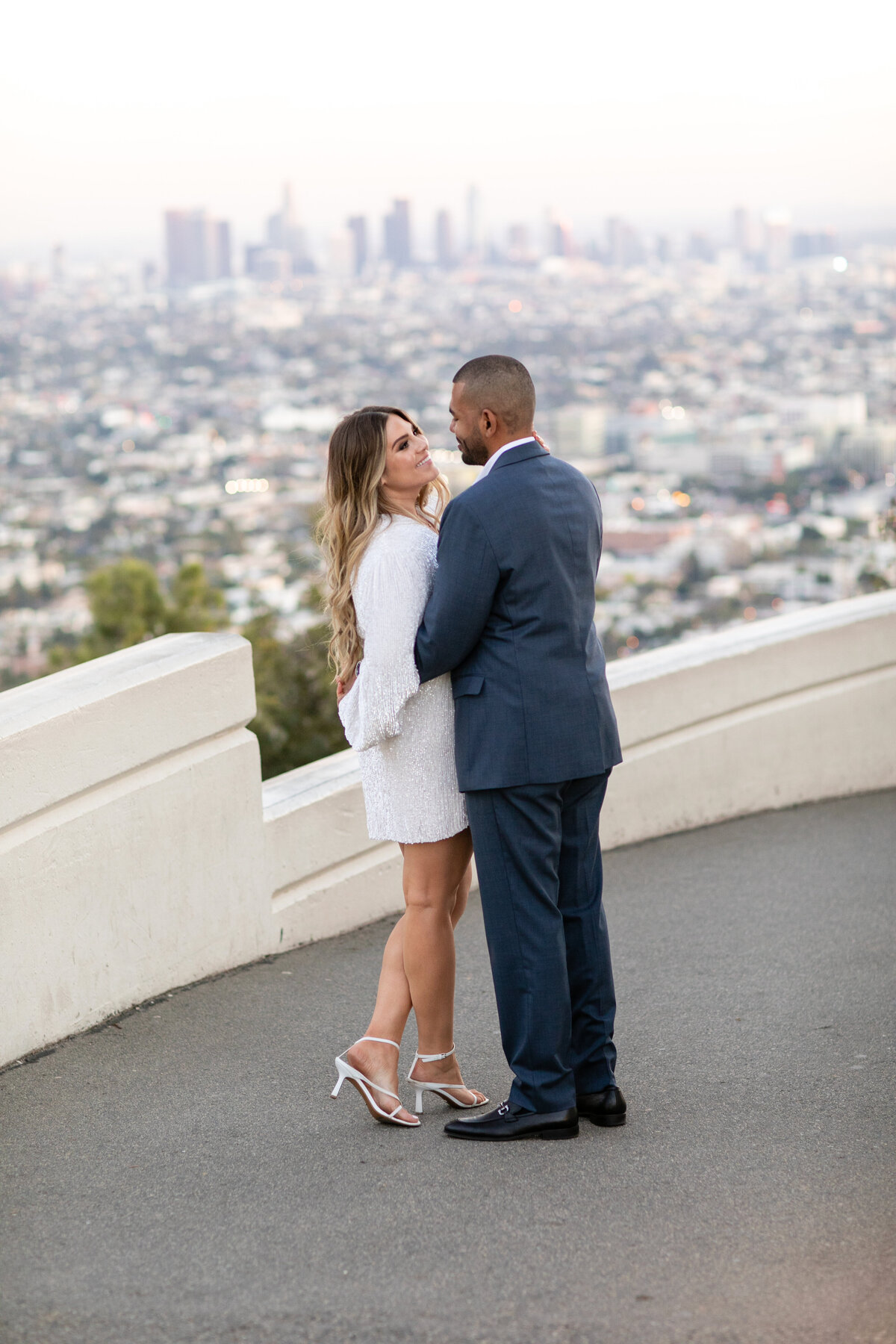 Couple looking at each other at their engagement session at Griffith observatory