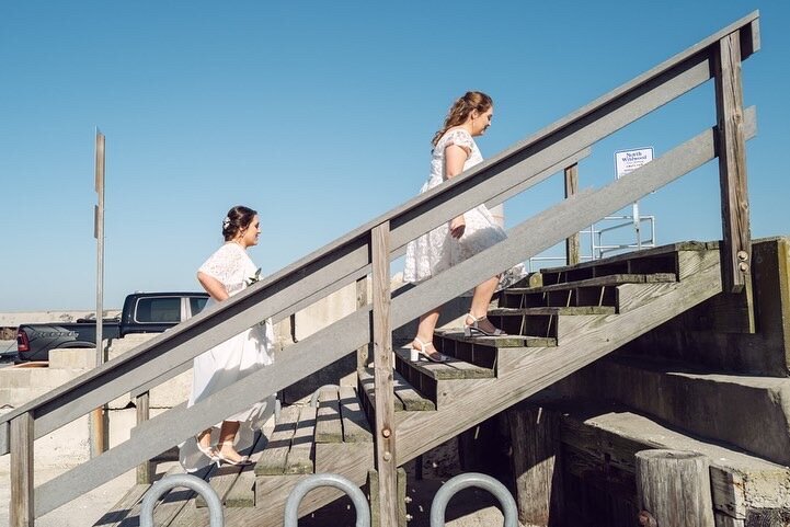 Two brides walk up the stairs