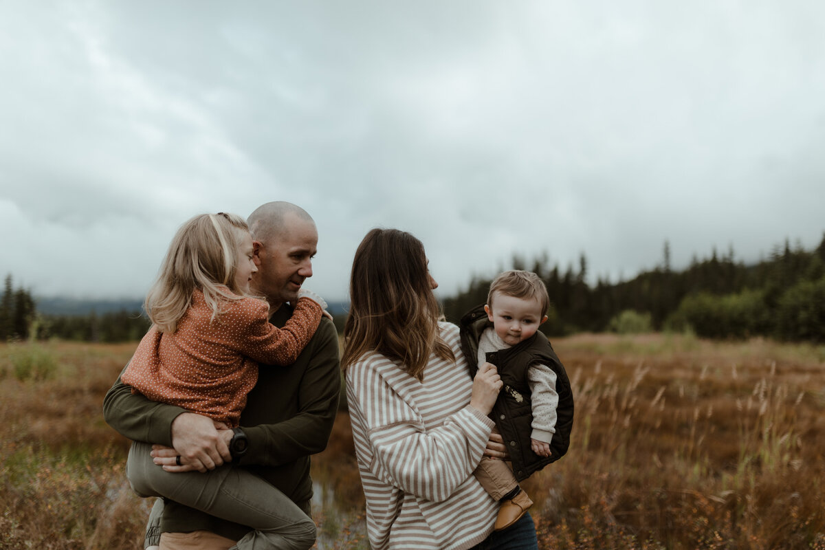 family embracing in field