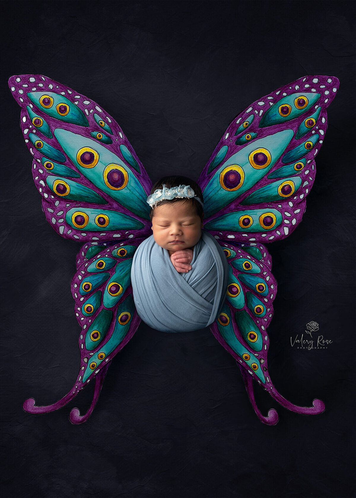 newborn laying with butterfly wings
