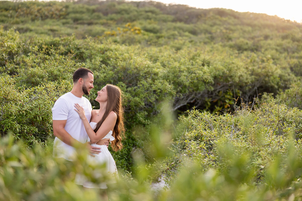 newly married couple honeymooning on 30a taking pictures at grayton beach state park on the trail.