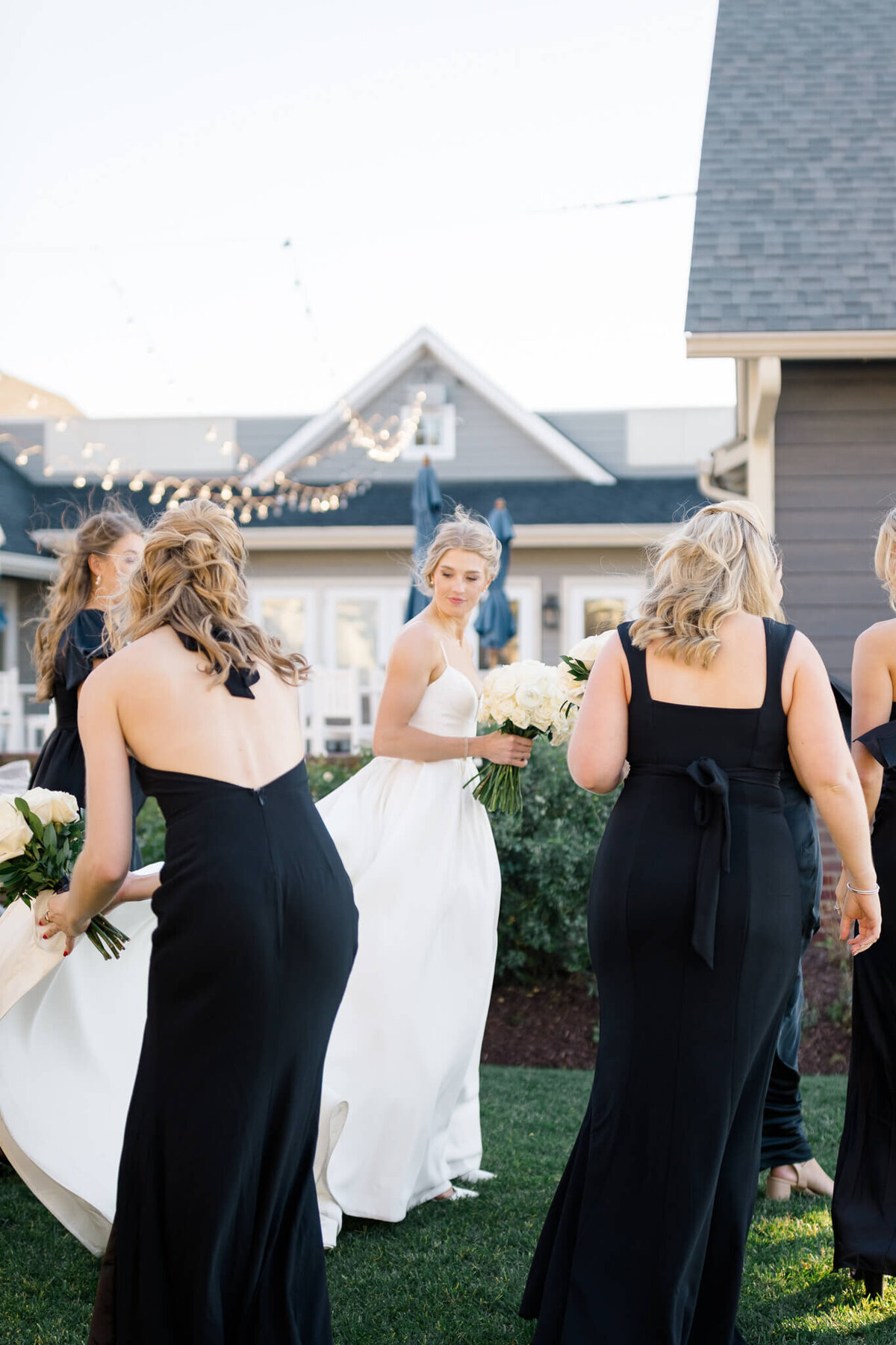 Bridesmaids helping Bride carry her train at the Chesapeake Bay Beach Club.