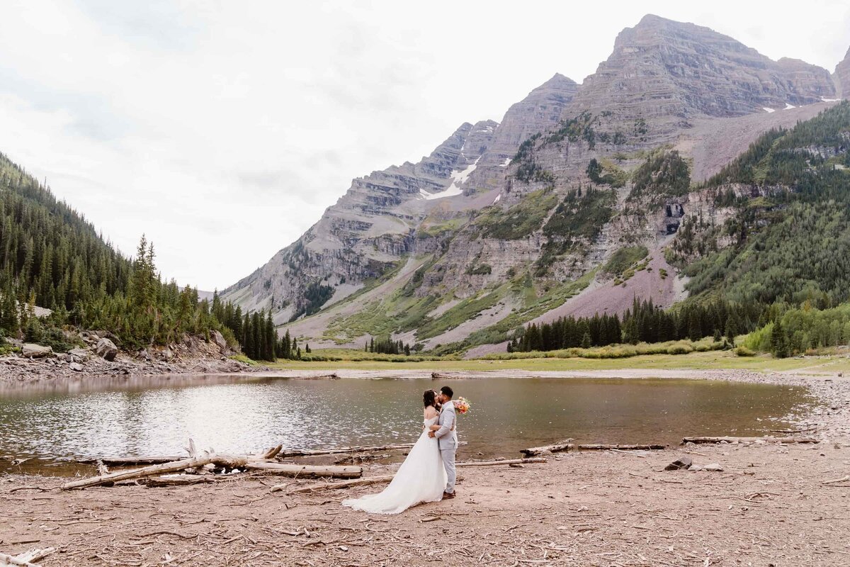 Couple sharing an intimate moment at Crater Lake in Aspen Colorado, captured by Alpine Vows, Colorado elopement photography and videography specialists.