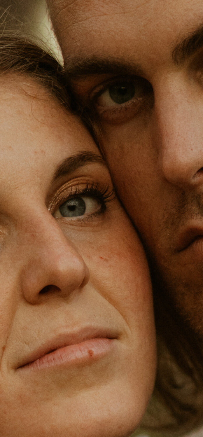 Couple posing for portraits in a forest.