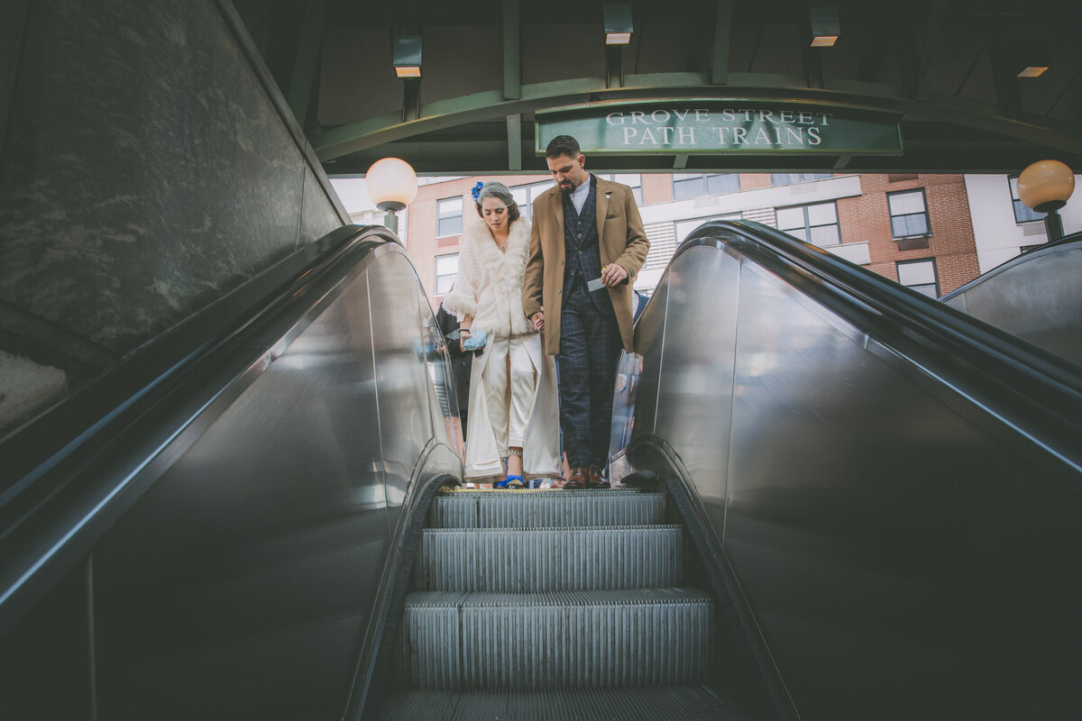 Bride and groom goes down a subway escalator during their elopement in Jersey City.