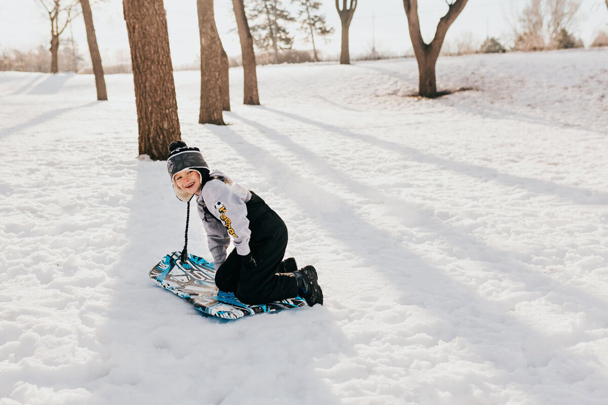 boy-having-fun-sledding