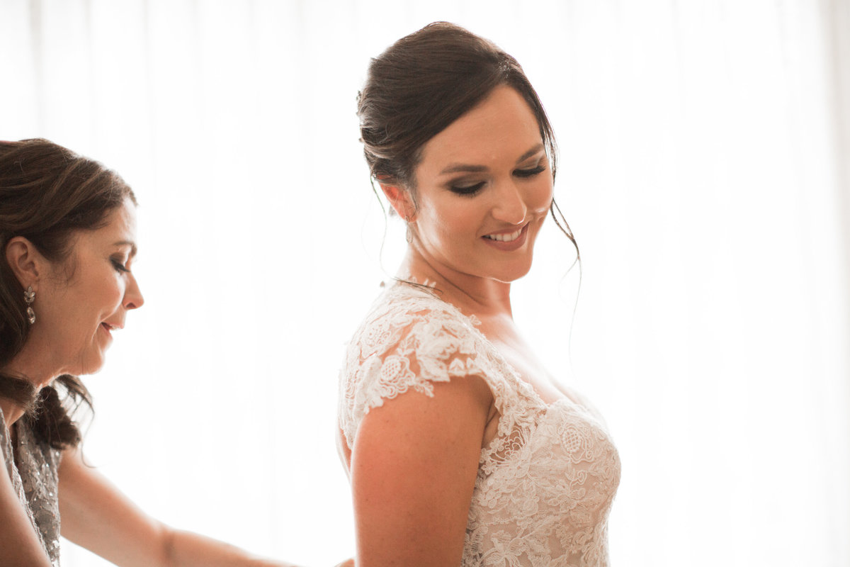 Bride getting into dress at 1880 Union Hotel Wedding