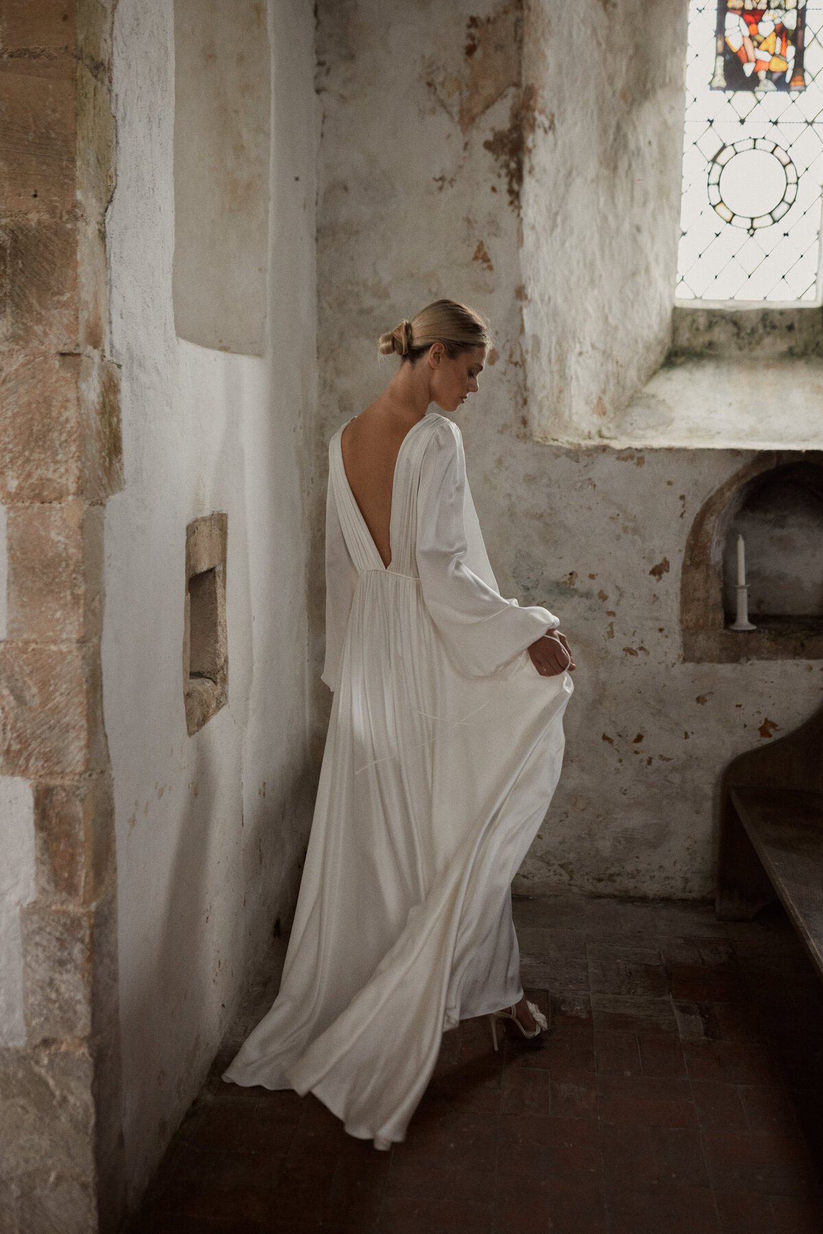Benjamin Wheeler photography of bride wearing long-sleeved, elegant low v neck silk wedding dress