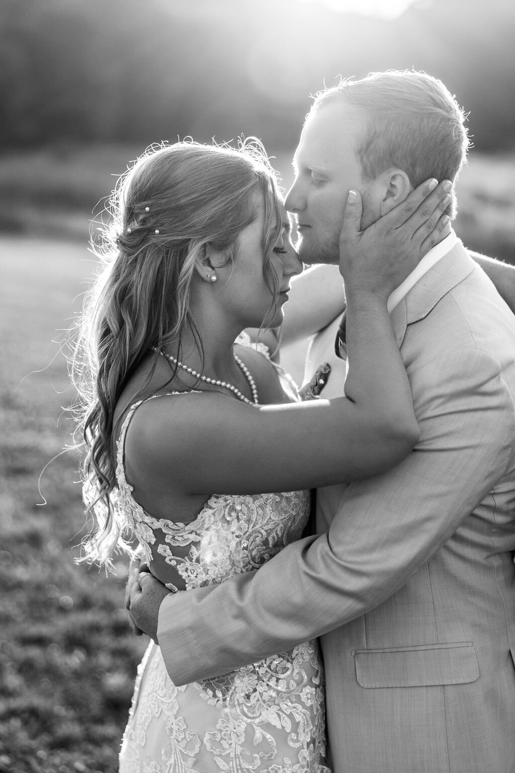 Bride and groom embracing at golden hour