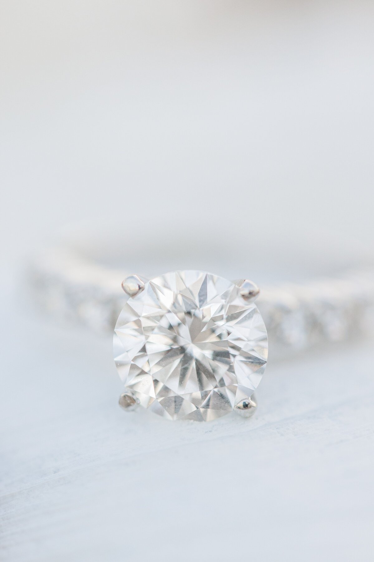 A close up of a solitaire diamond during a Wingaersheek Beach engagement session.