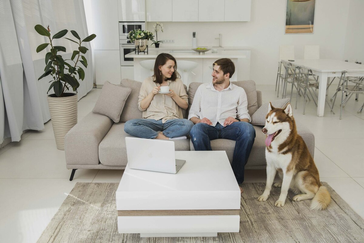 Couple sitting in their living room with dog