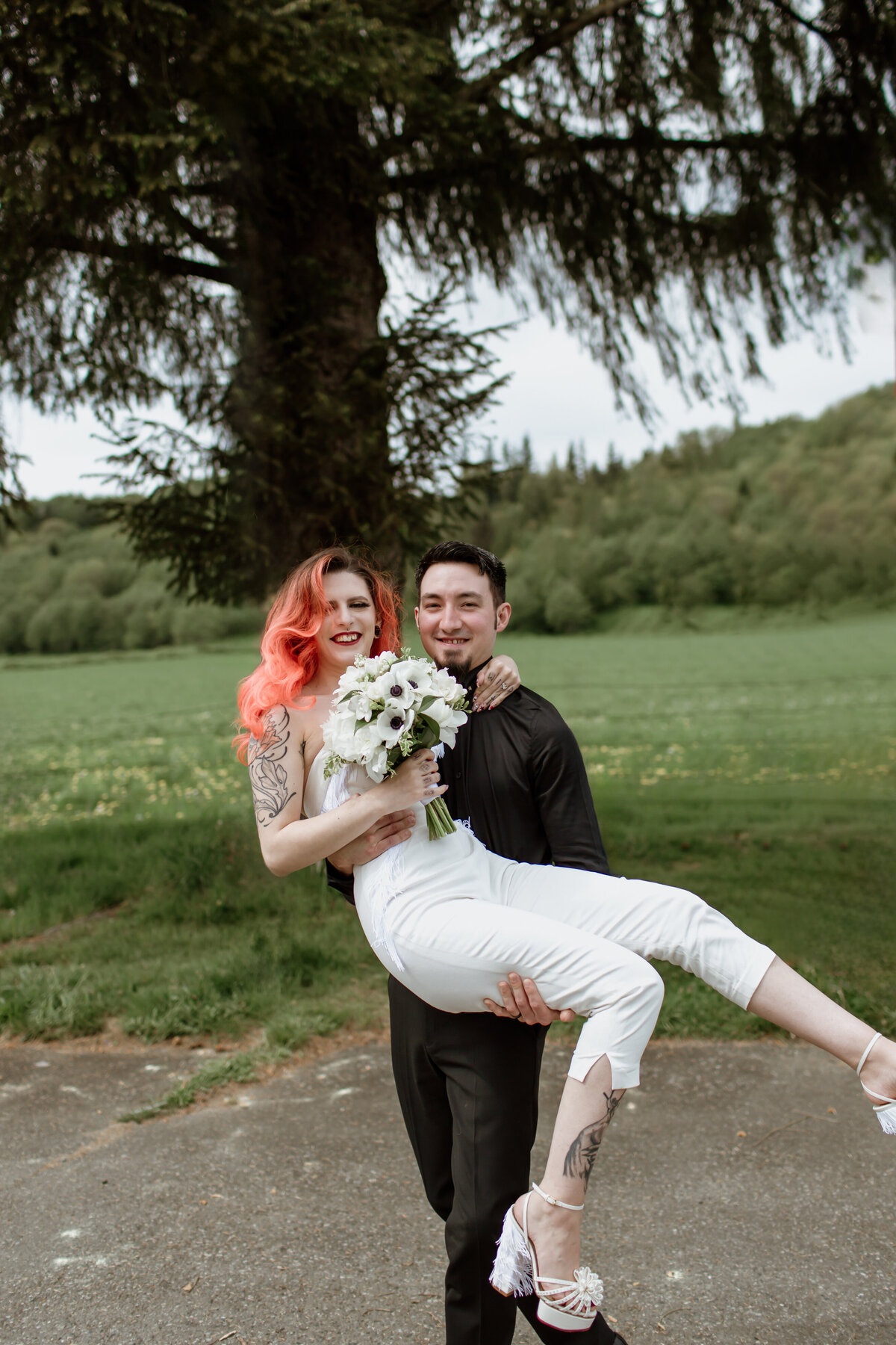A fun moment of a bride and groom celebrating after their non-traditional wedding. Captured by Fort Worth wedding photographer, Megan Christine Studio