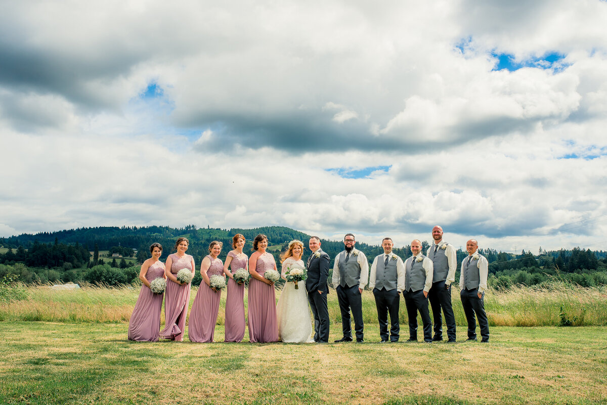 large bridal party and clouds
