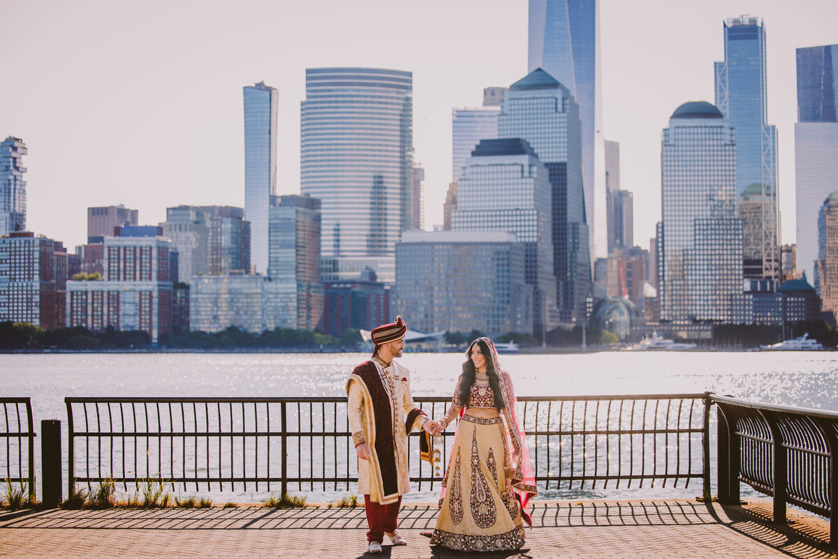 Indian bride and groom at the pier of the jersey city hyatt overlooking the nyc skyline after the first look on the wedding day