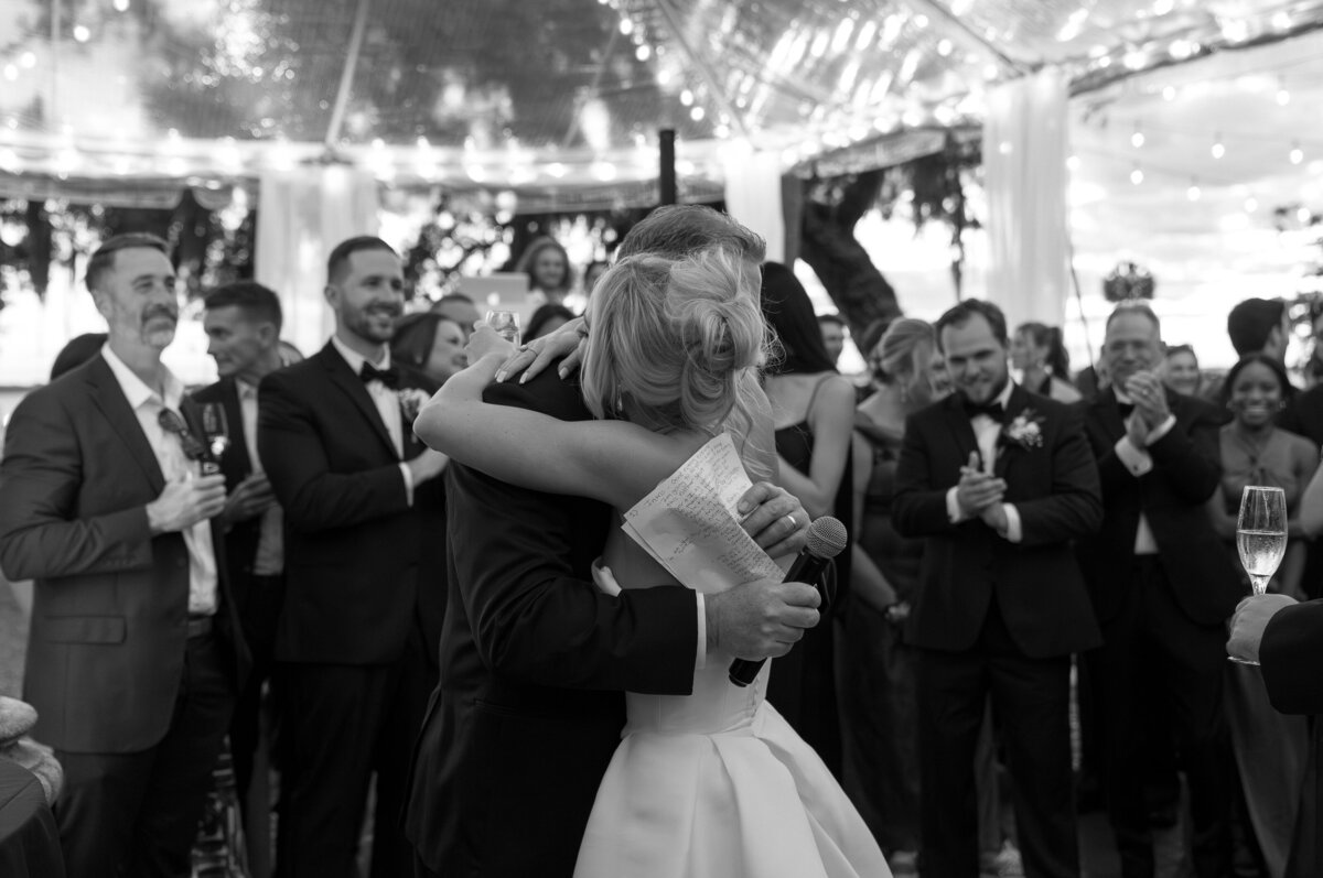 bride hugging father at wedding reception by destination wedding photographer