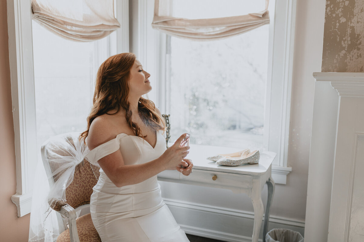 bride spraying perfume