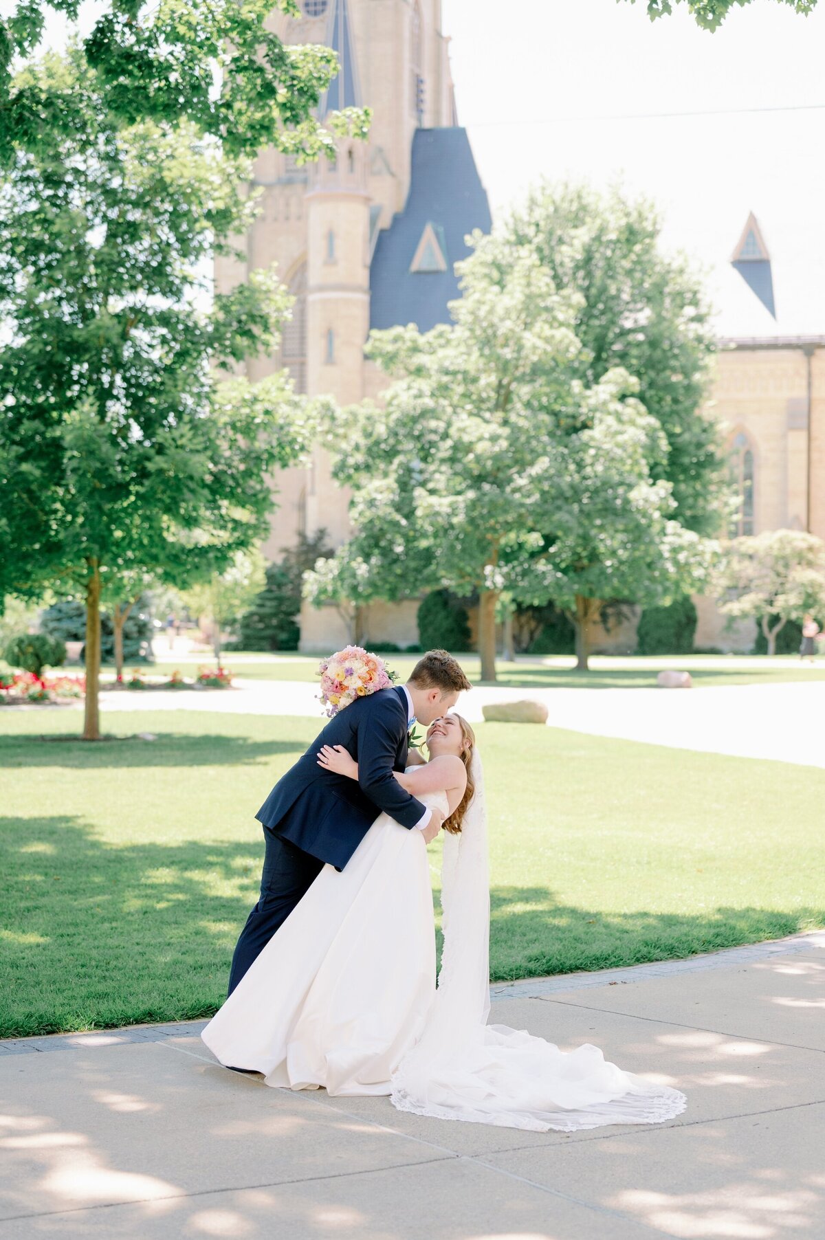 groom about to kiss bride on Notre Dame's campus