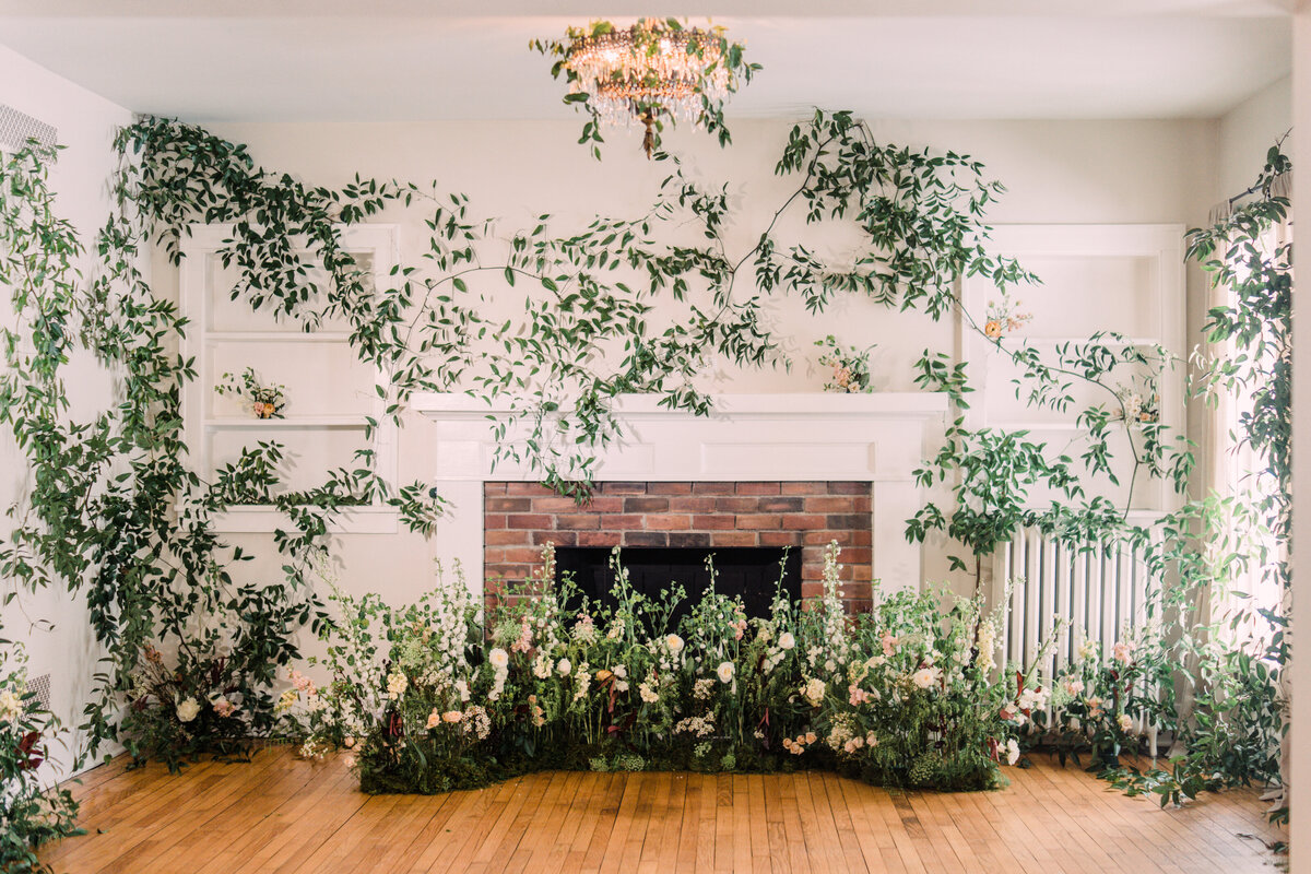 Dining room at Zingerman's Cornman Farms decorated with enchanted indoor garden wedding ceremony nest & vine-covered walls