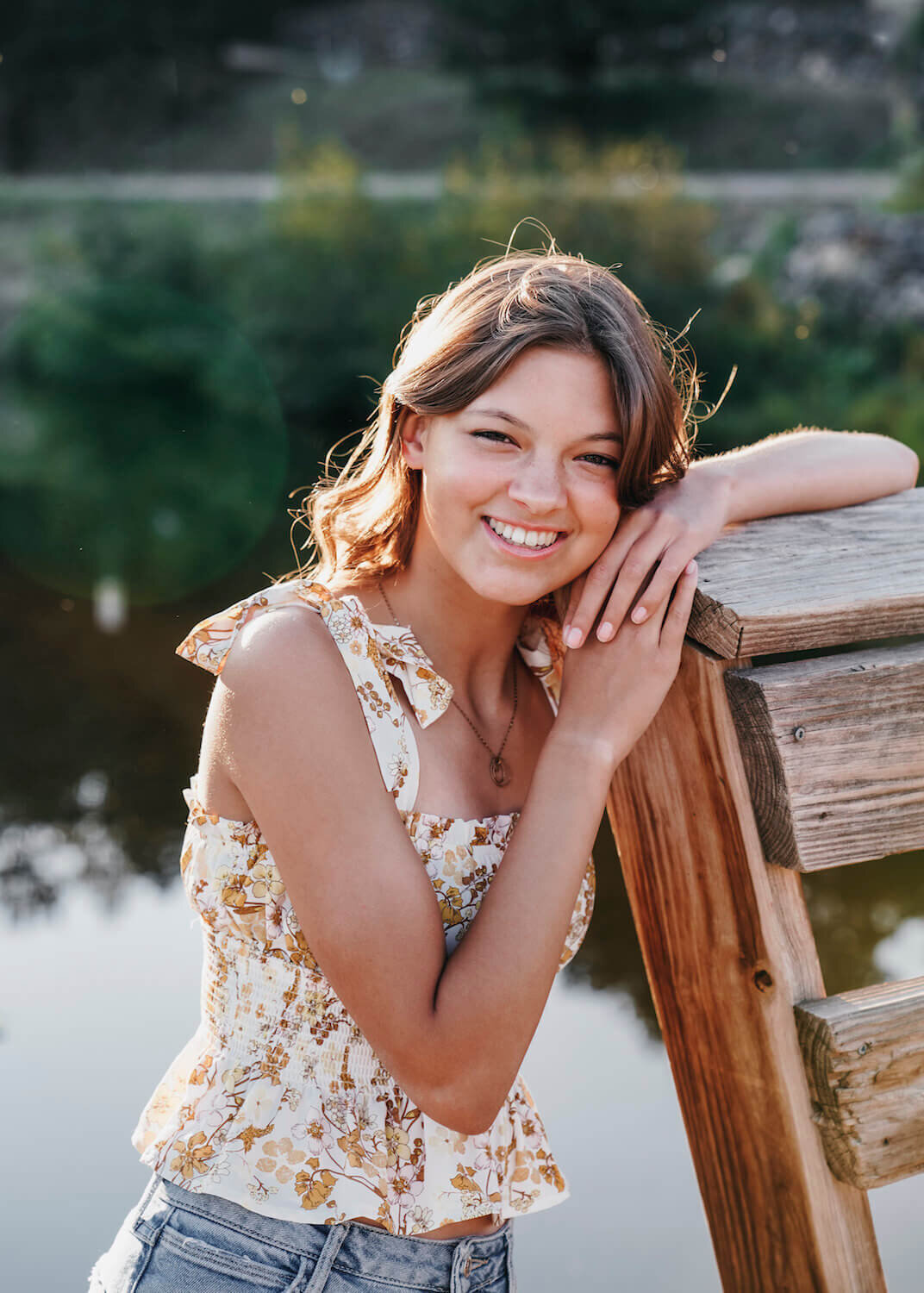 senior photography denver - teen girl smiling by water