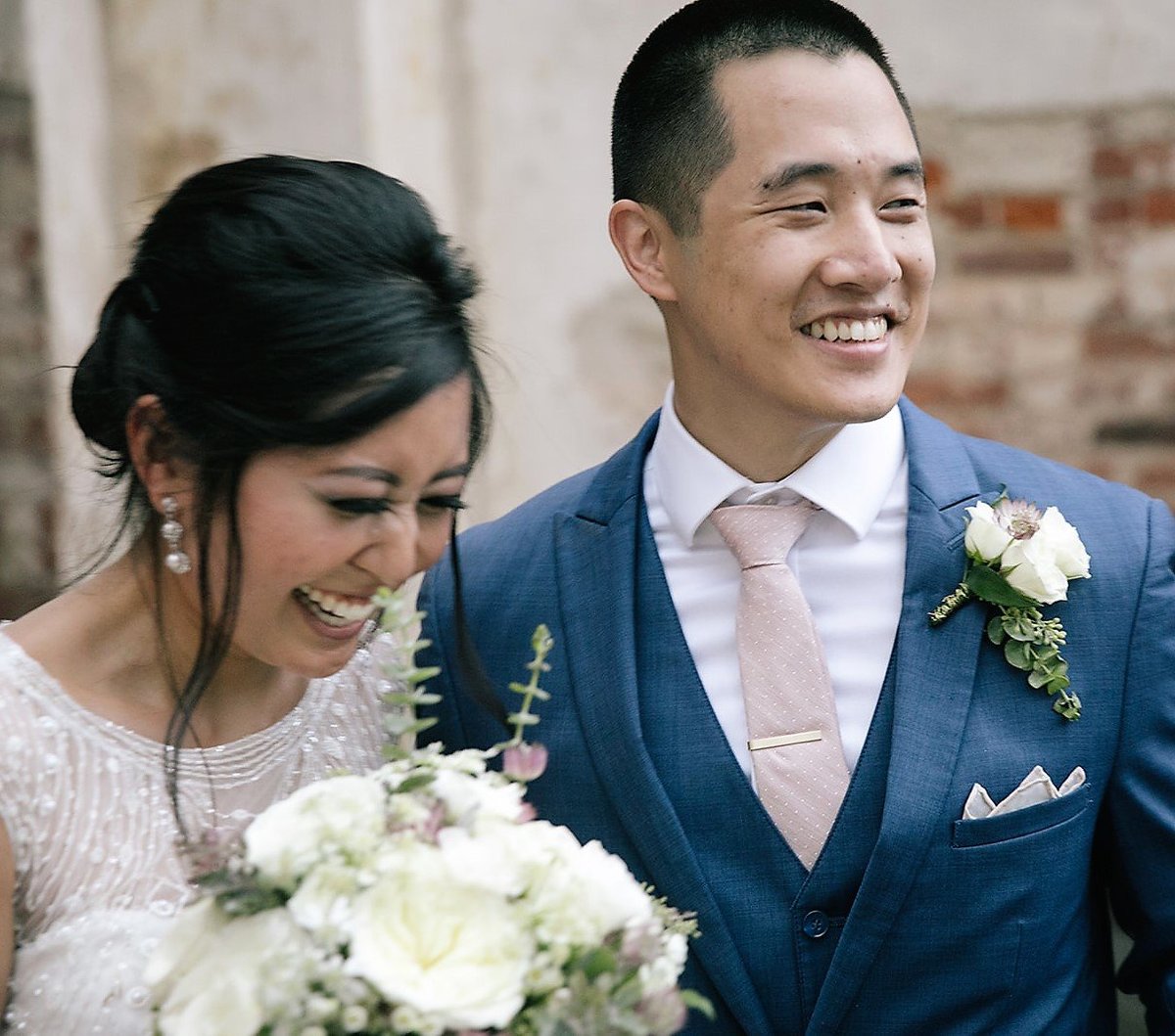 Bride with white bouquet and groom