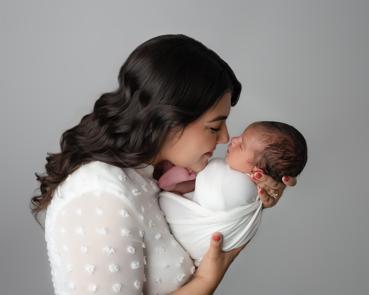 Studio family photo of mother holding newborn face to face | Meraki Photographic Creations Paris Ontario