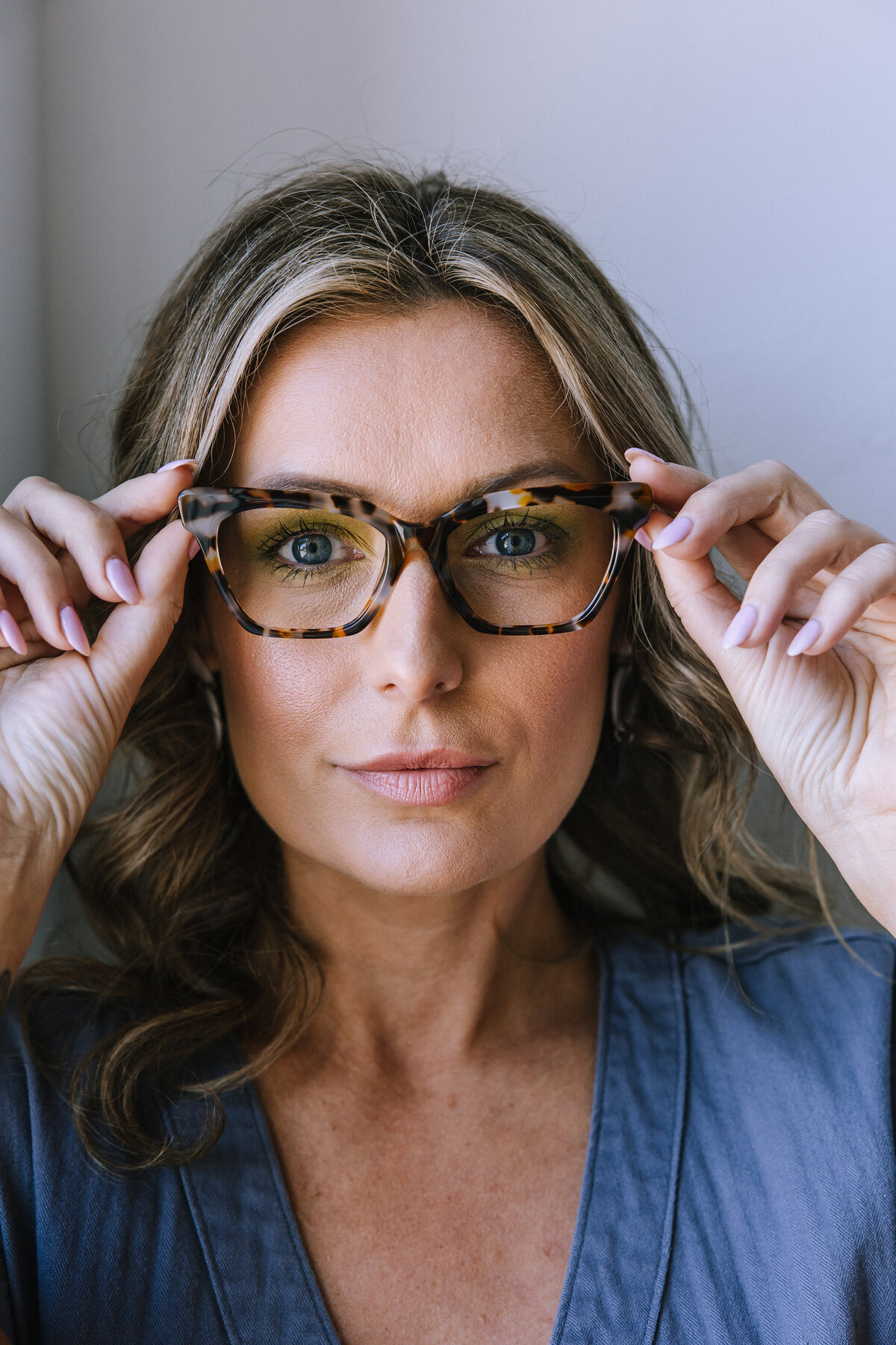 Woman wearing glasses for branding photos for North Point Eyewear of Pittsburgh. 