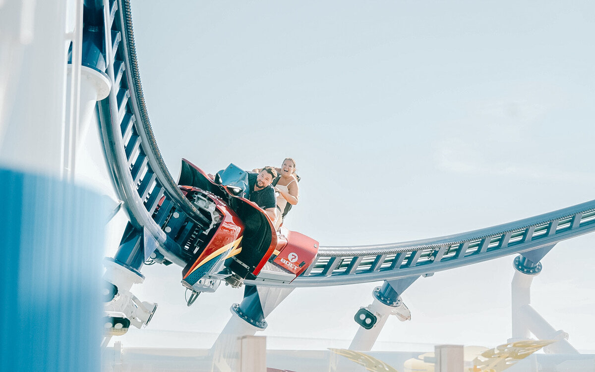 a bride and groom on a rollercoaster on their cruise ship wedding
