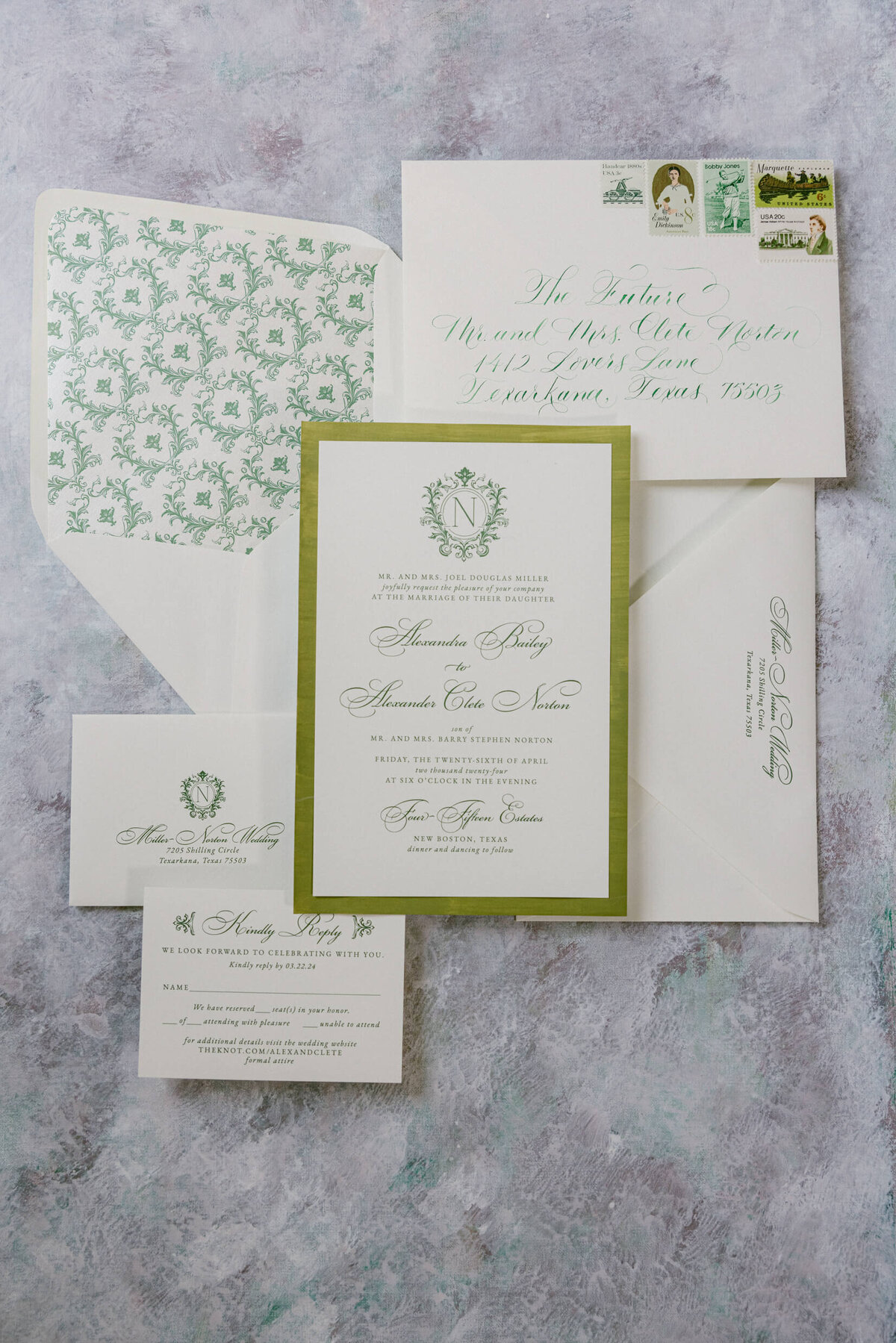 A wedding day photo of the wedding invitations laid out on a linen backdrop