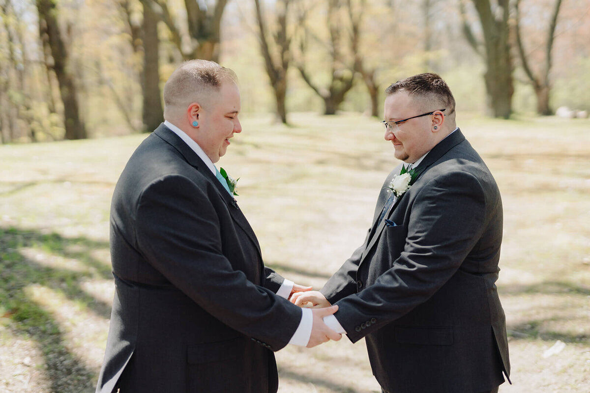 Gay couple holding hands at Rochester wedding, NY