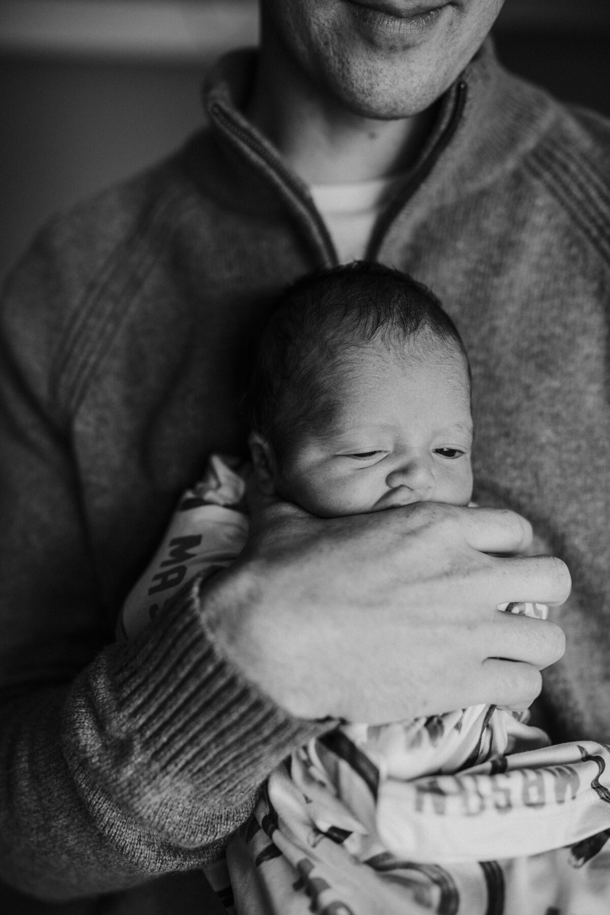 New dad holding newborn baby boy in Plymouth, MN