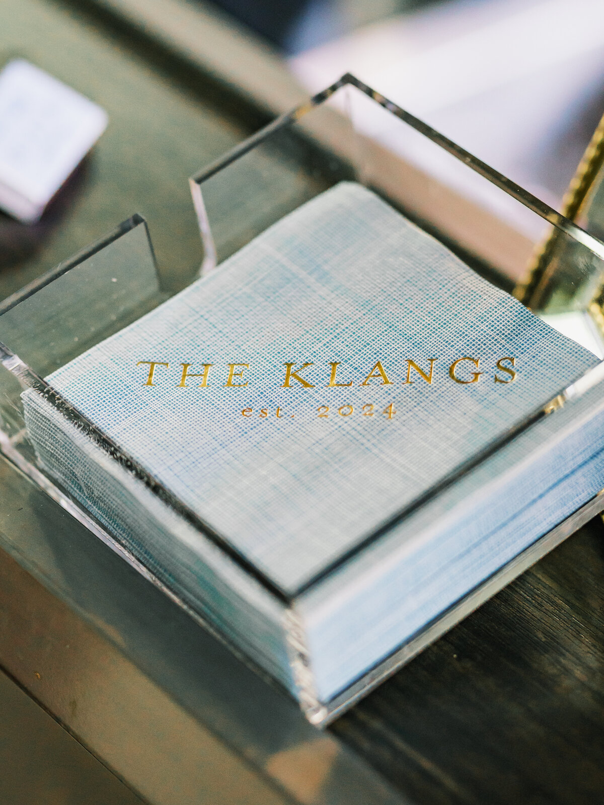 Stack of custom monogrammed cocktail napkins displayed at a wedding reception at Old Edwards Inn in Highlands, North Carolina.
