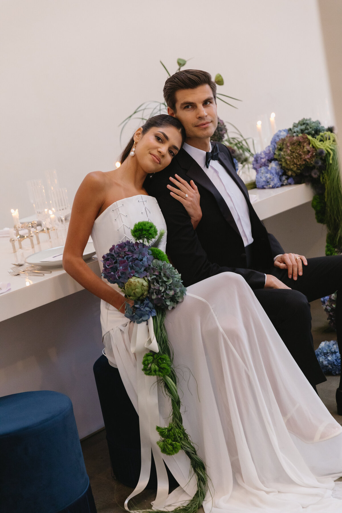 Bride and groom seated together during an elegant modern wedding editorial in New York.