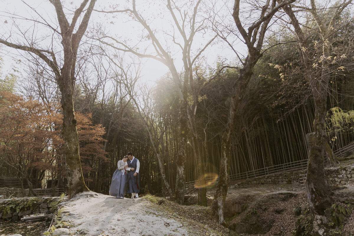 the bride leaning her head in the groom's shoulder while standing in soswaewon garden damyang south korea