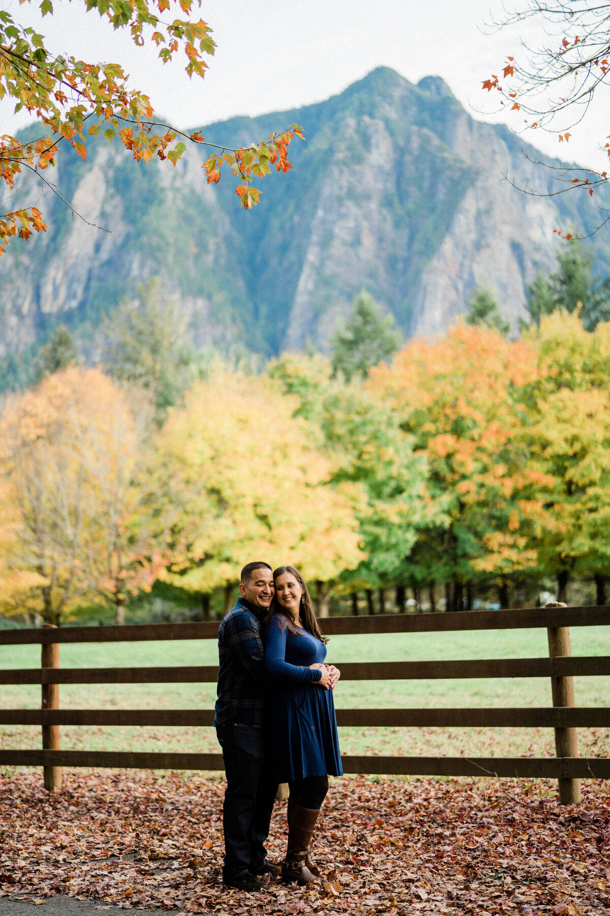 Couple standing in front of Mount Si taking engagement photos, Rockwood Farm is the best spot for engagement pictures in Seattle.