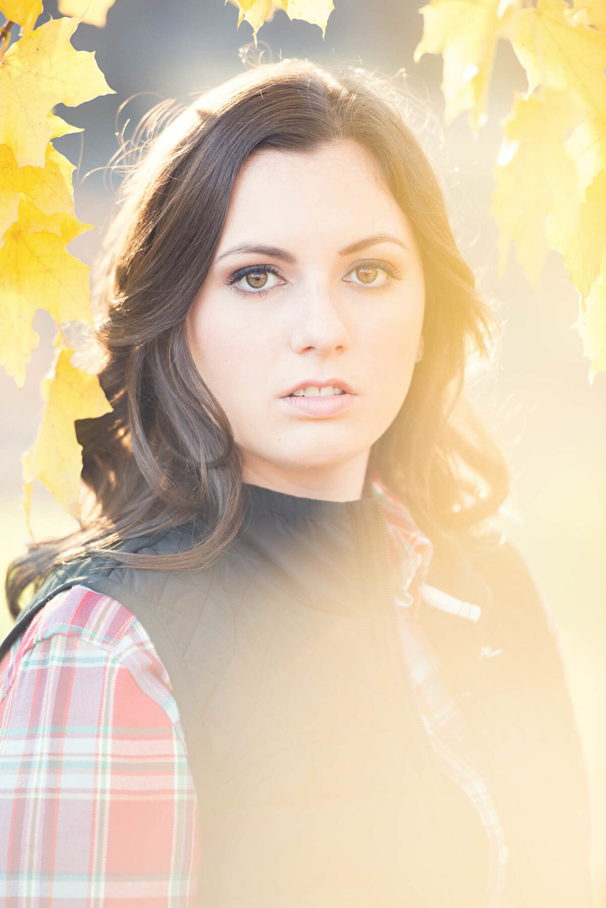 Girl with fall leaves senior portraits